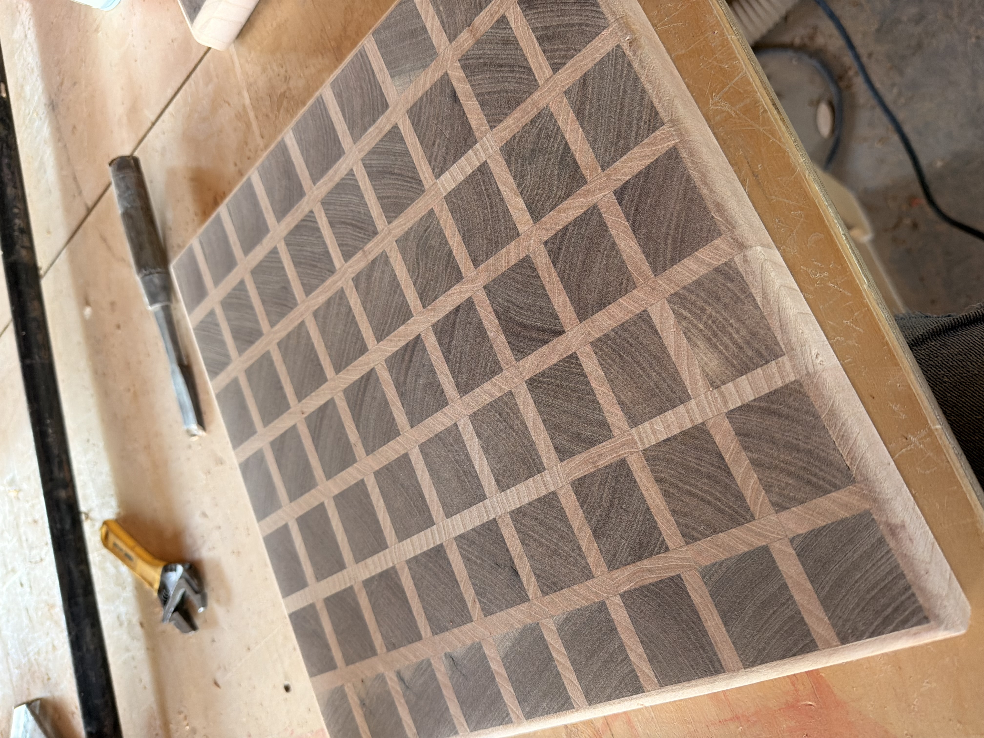 A cutting borad made from walnut and cherry lumber in a grid pattern